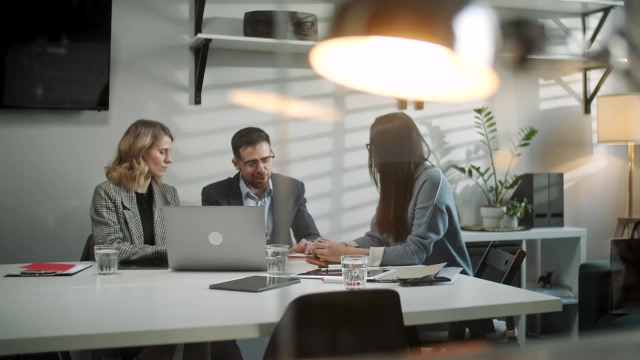 Attorneys meeting with a client around a conference table