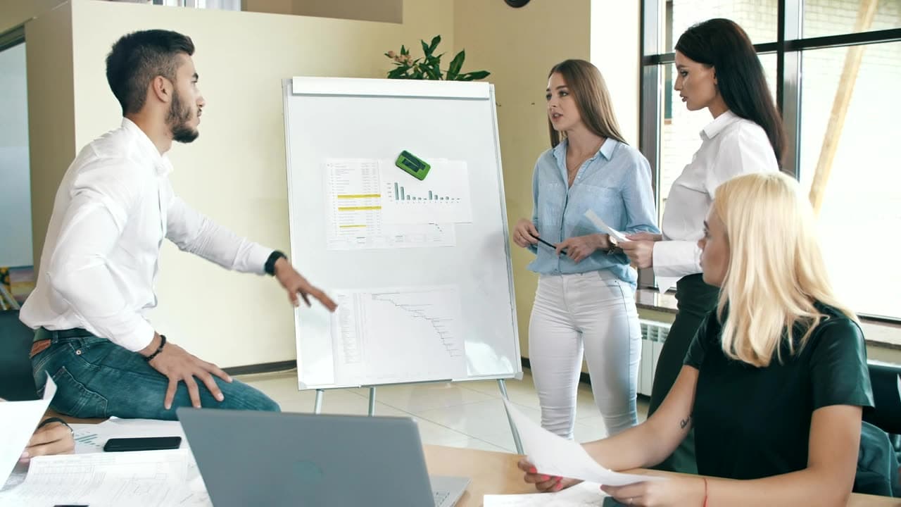 A small team planning together at a whiteboard